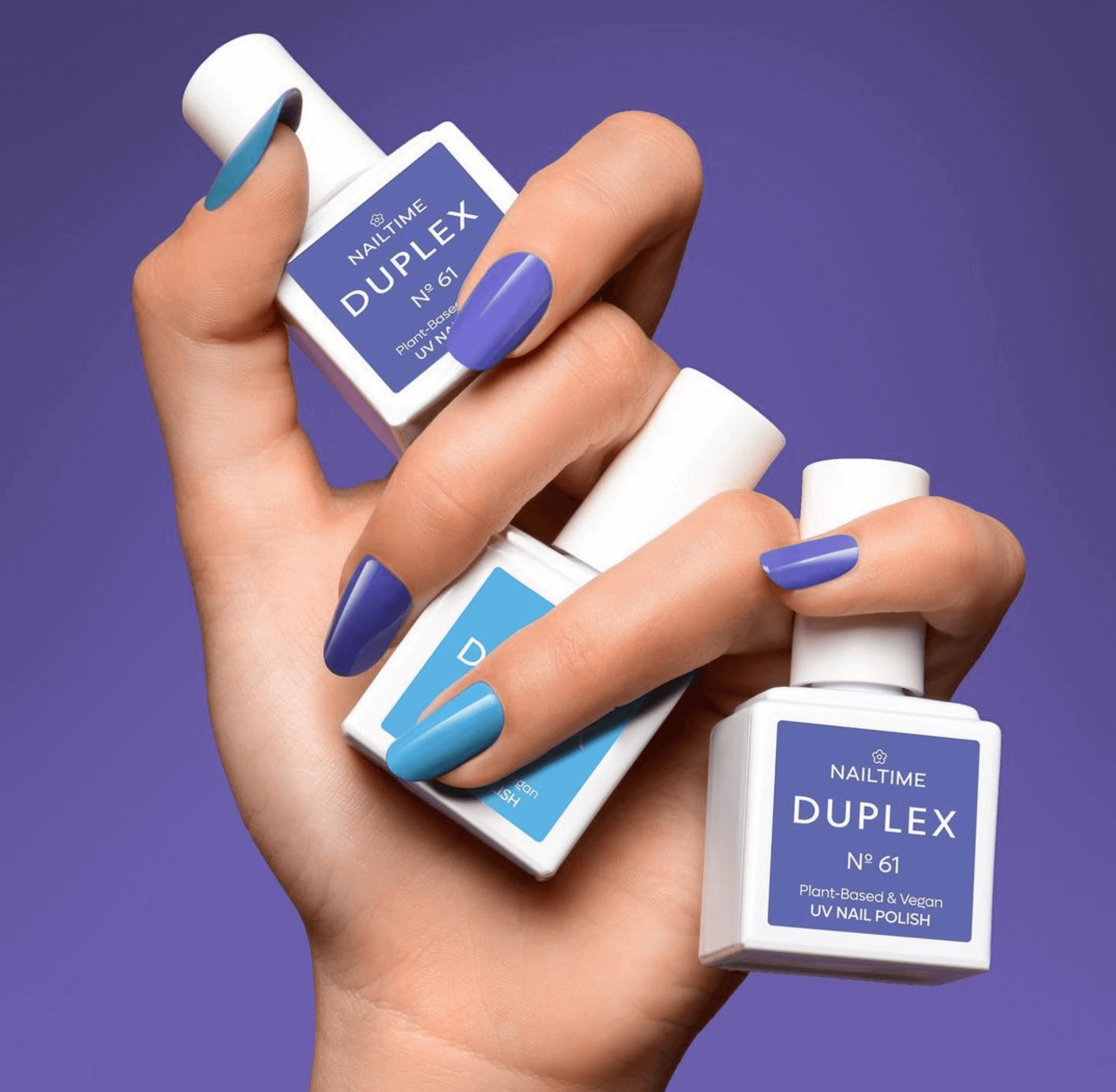 💅🏻 Hand holding 3 bottles of DUPLEX 🅝61 🖌️ plant-based UV polish for long-lasting nail beauty. Nailtime 💜