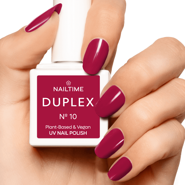 DUPLEX No.10 vegan UV nail polish in dark raspberry pink on manicured hand, drying in 90 seconds with plant-based formula.