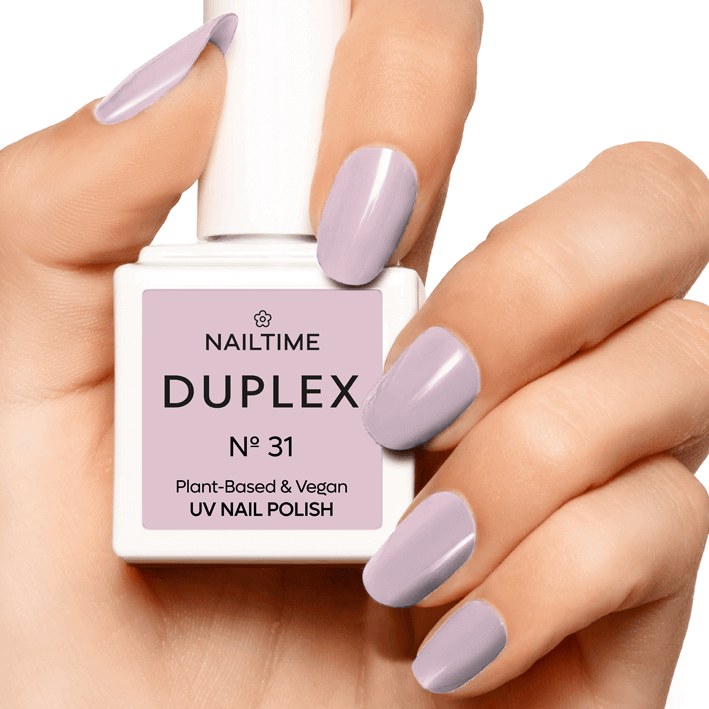 DUPLEX No.31 Sugar Daddy vegan UV nail polish on manicured hand in pastel peach with golden shimmer.