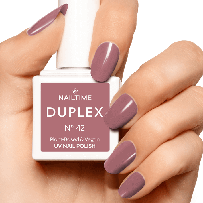 DUPLEX N°42 UV nail polish, plant-based and vegan, displayed on manicured hand with mauve nails.