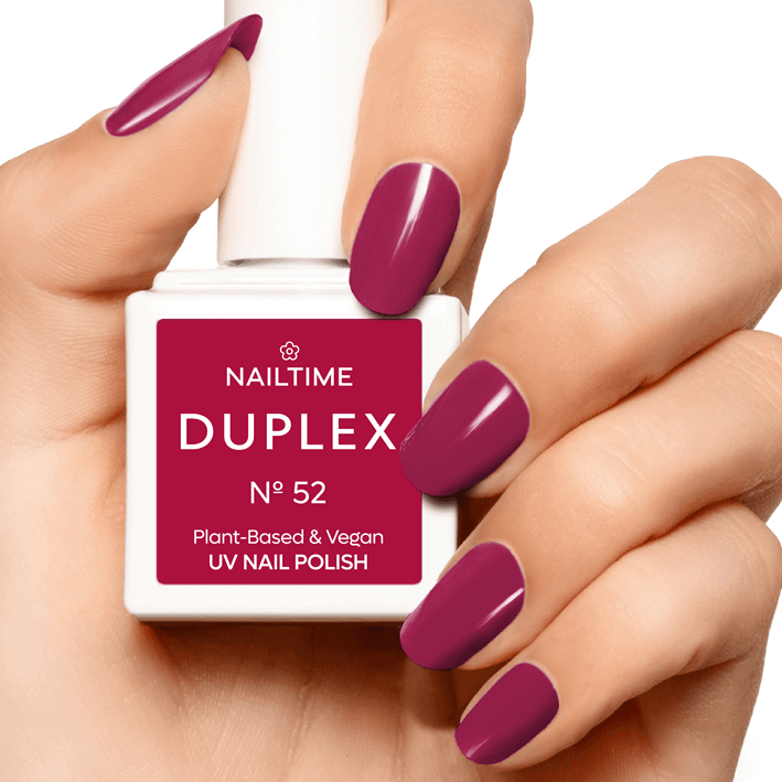 DUPLEX No.52 Rebell Rose UV nail polish in fuchsia pink on manicured hand, plant-based and vegan formula.