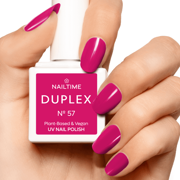 DUPLEX No.57 UV nail polish in vibrant magenta-red held in hand, plant-based, vegan formula, dries in 90 seconds.