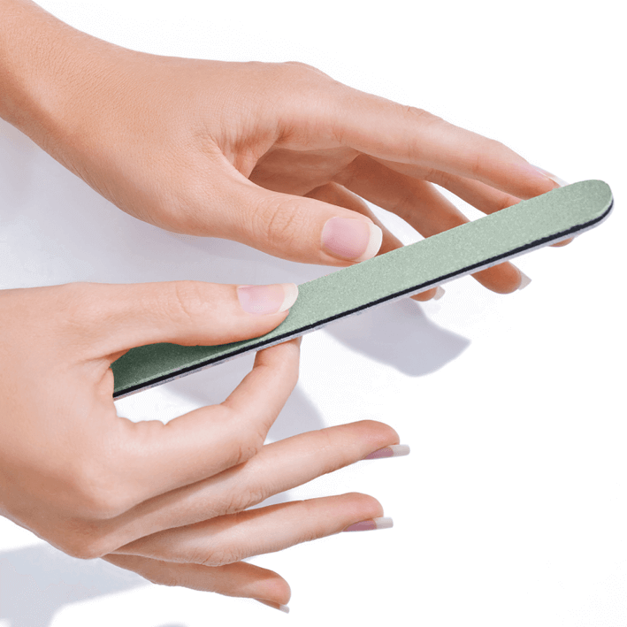 Hand using NAILTIME HIGH SHINER polishing file for a high-gloss nail finish with mint green coating.
