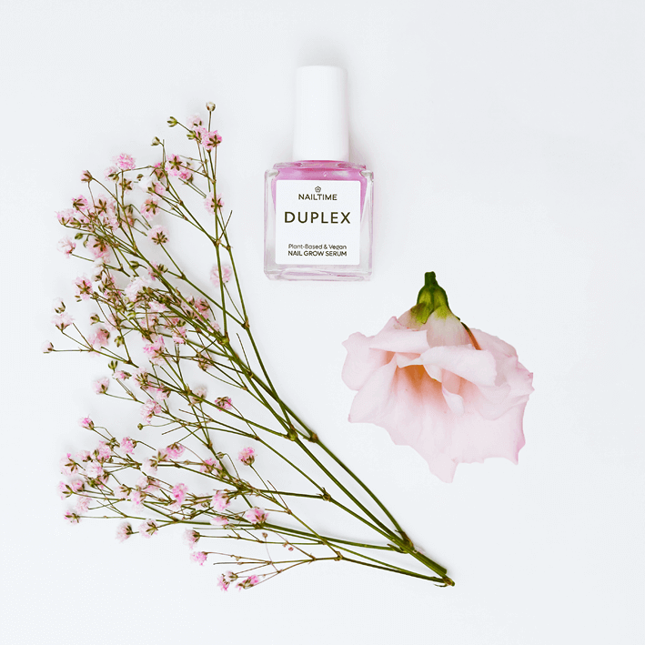 DUPLEX Nail Grow Serum with pink flowers; vegan formula for healthy, strong nails enriched with natural ingredients.
