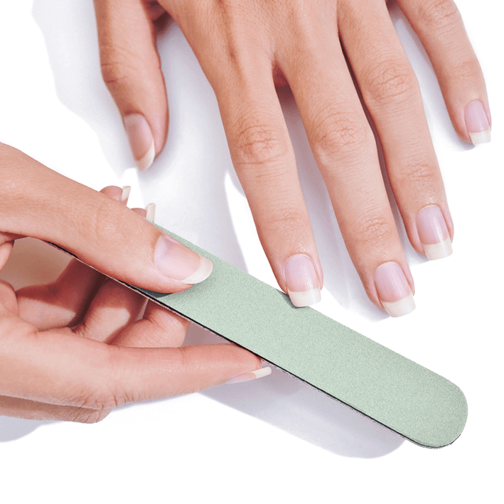 Person polishing nails with NAILTIME HIGH SHINER polisher for a glossy finish, featuring mint green design.